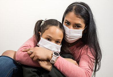 Latino Mother and Daughter Wearing Masks